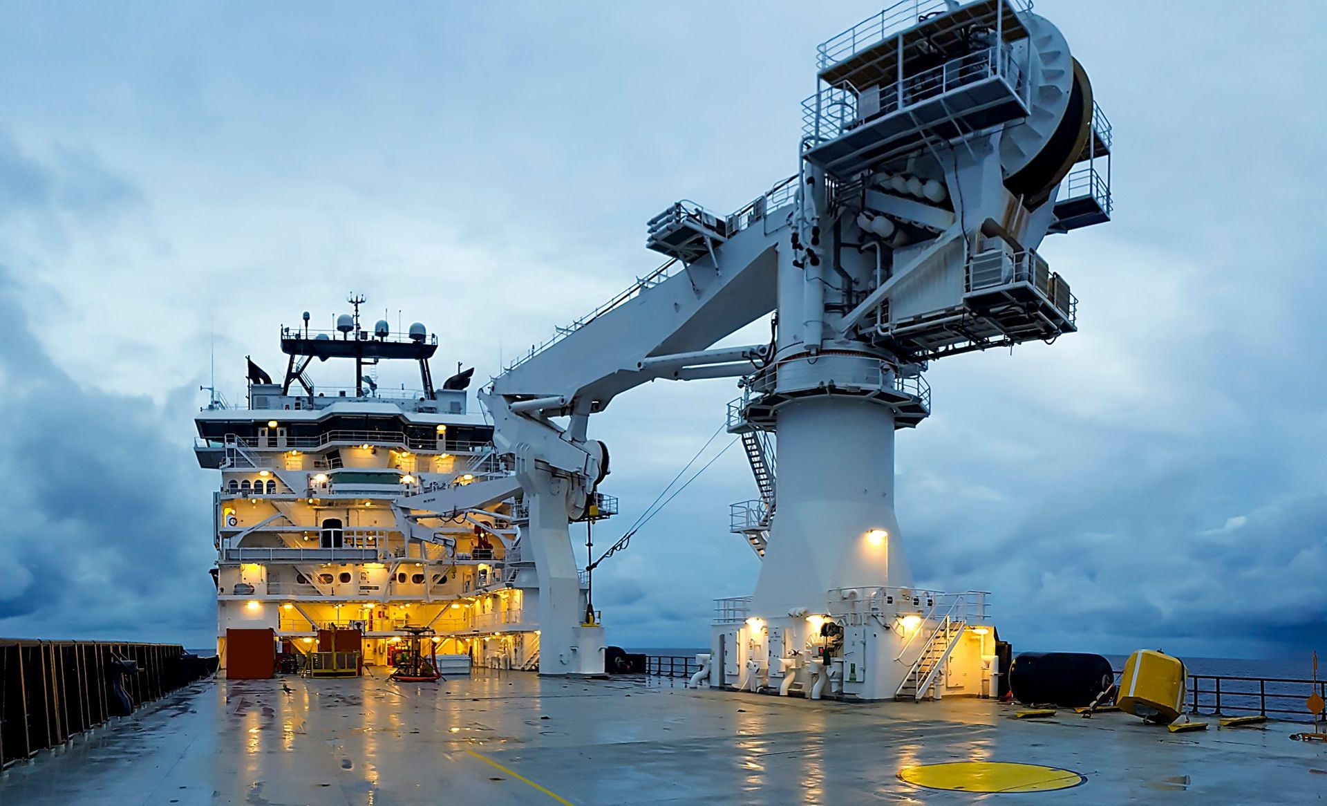 Deck and offshore crane of a construction vessel at dusk